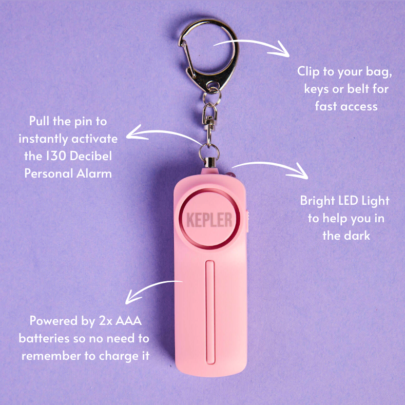 Pink personal alarm with keychain on a purple background, featuring text on how to use it.