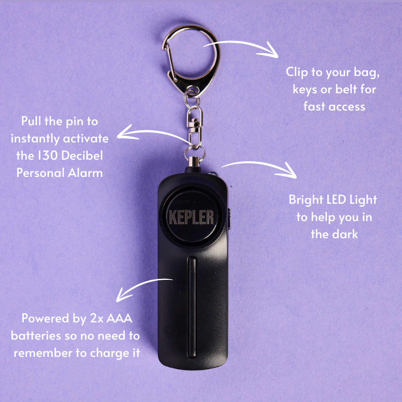Black personal alarm with keychain on a purple background, featuring text on how to use and features.